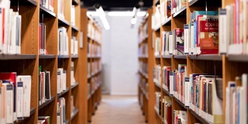 An aisle between two library shelves