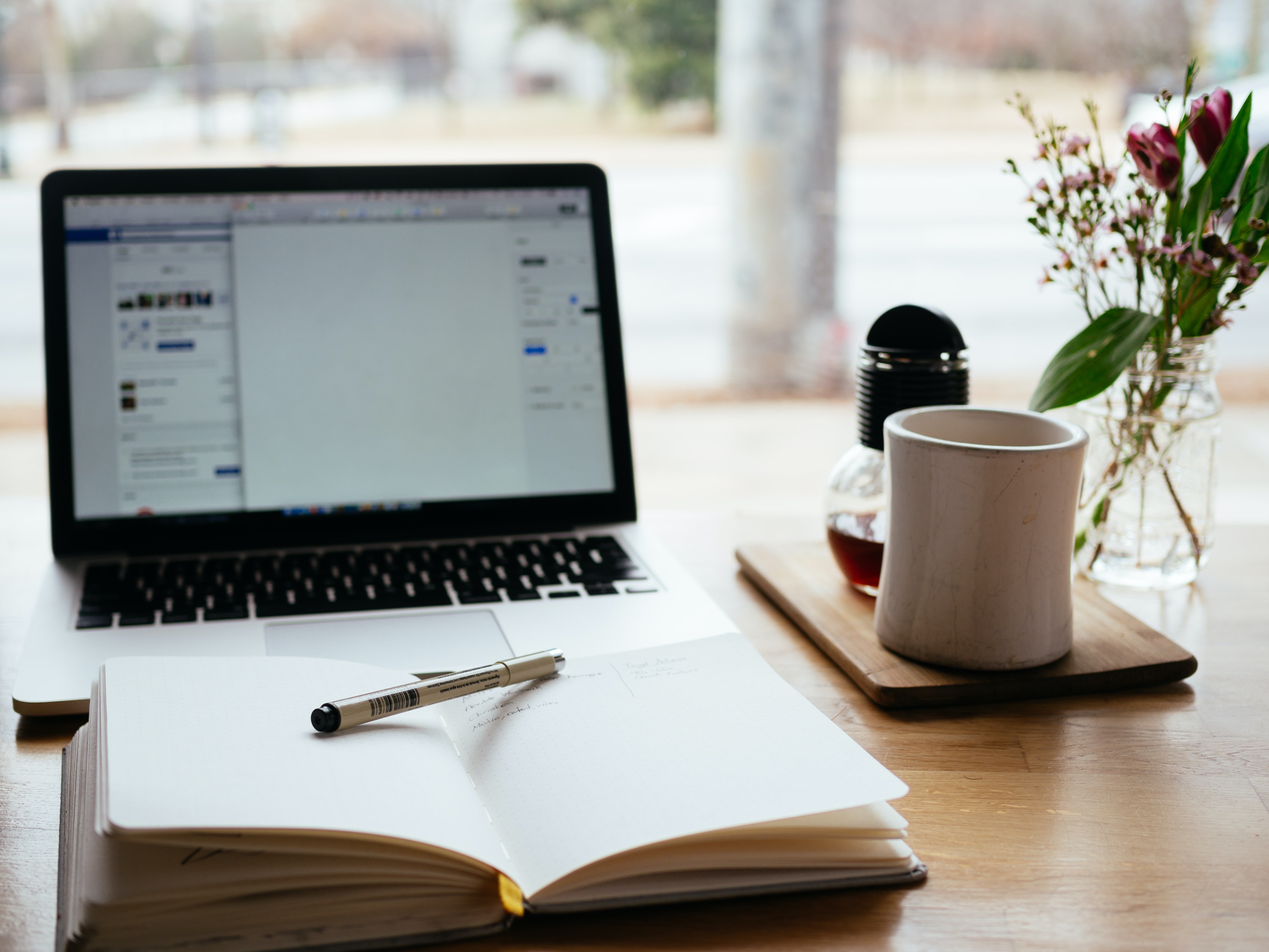 computer and coffee mug on a table or workspace