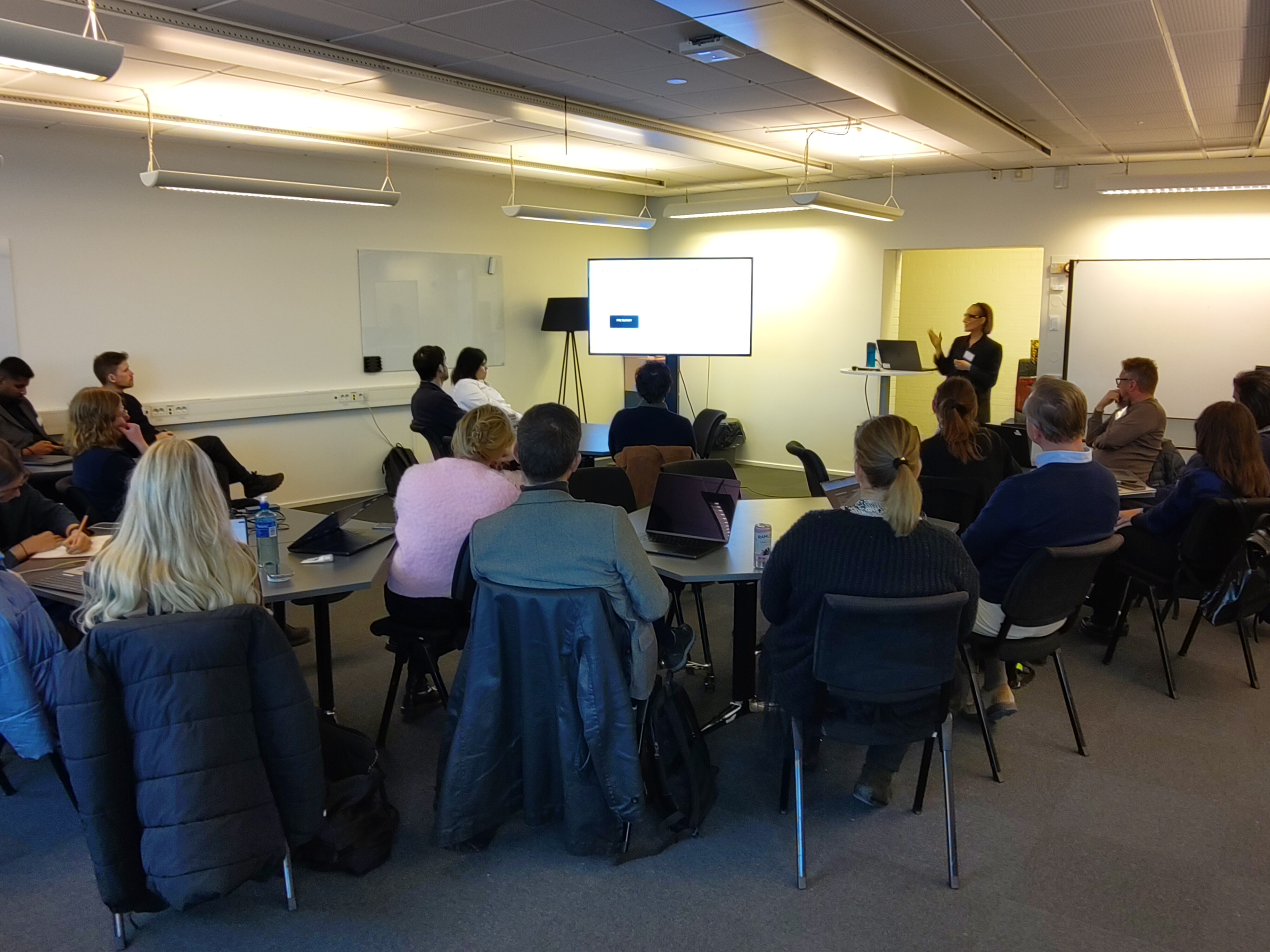 Workshop with participants listening to a presentation